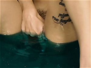 Alex De La Flor drains herself in blue water